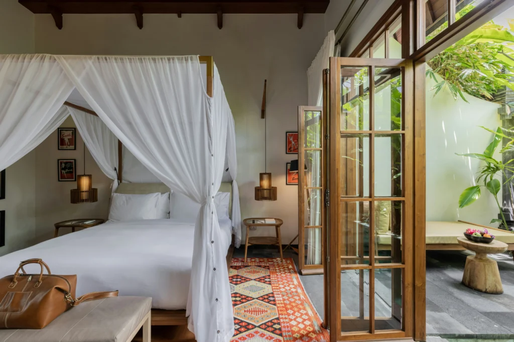 elegant boutique hotel bedroom with warm textures and natural materials