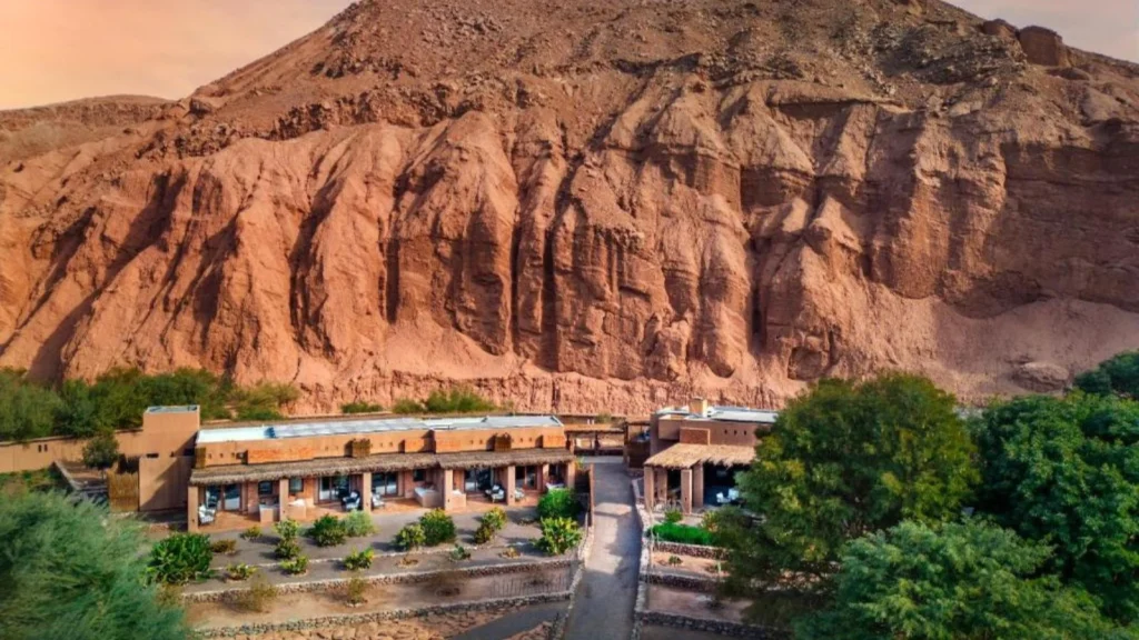 Atacama desert lodge blending into red canyon landscape
