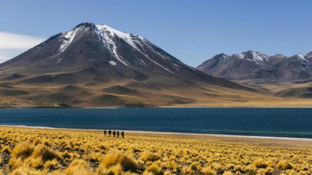 Wide view of Andean mountains rising above a quite high-altitude lagoon in Atacama