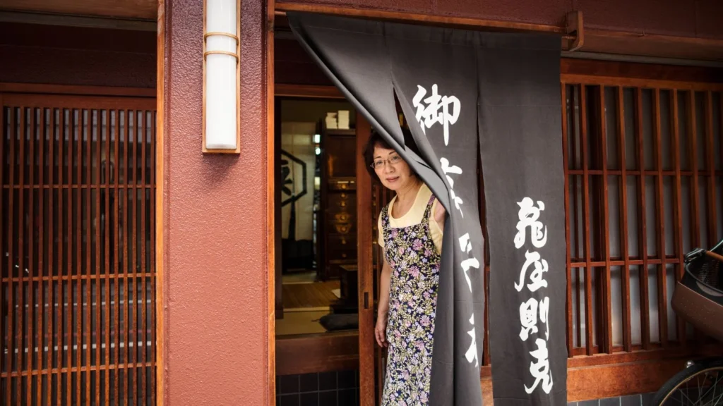 Japanese shop owner opens door in the morning, Kyoto