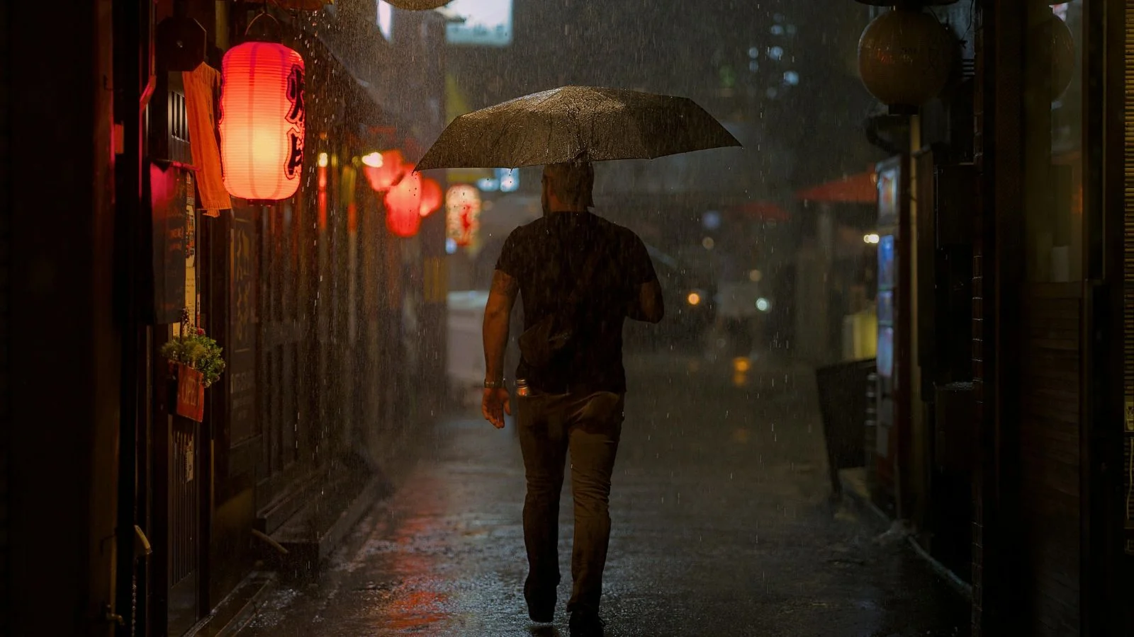 A man walking under rain in Kyoto