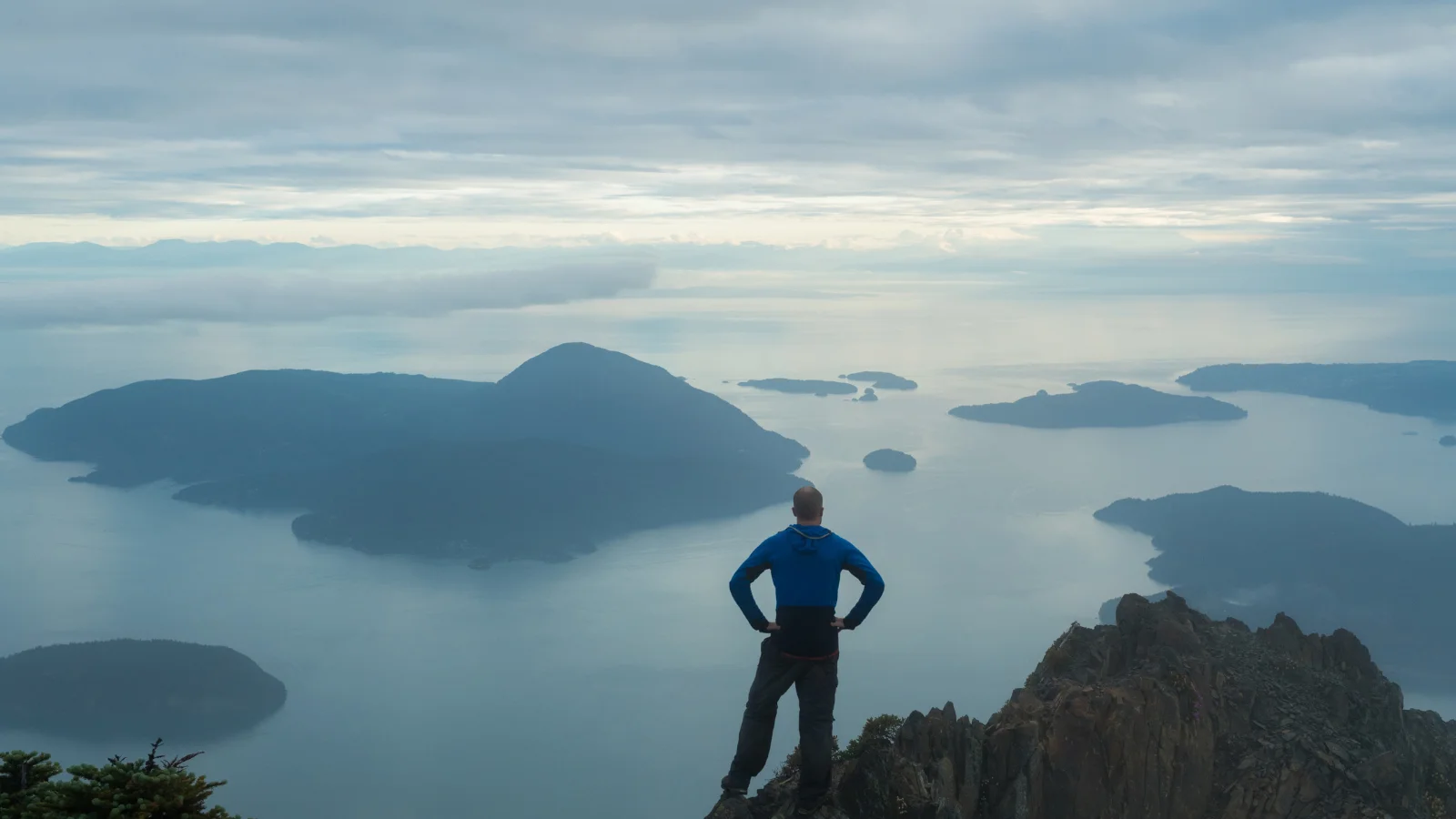 traveler observing lakes from mountain viewpoint in slow travel experience