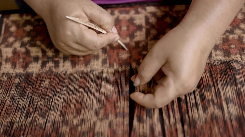 A Balinese woman weaving in Bali